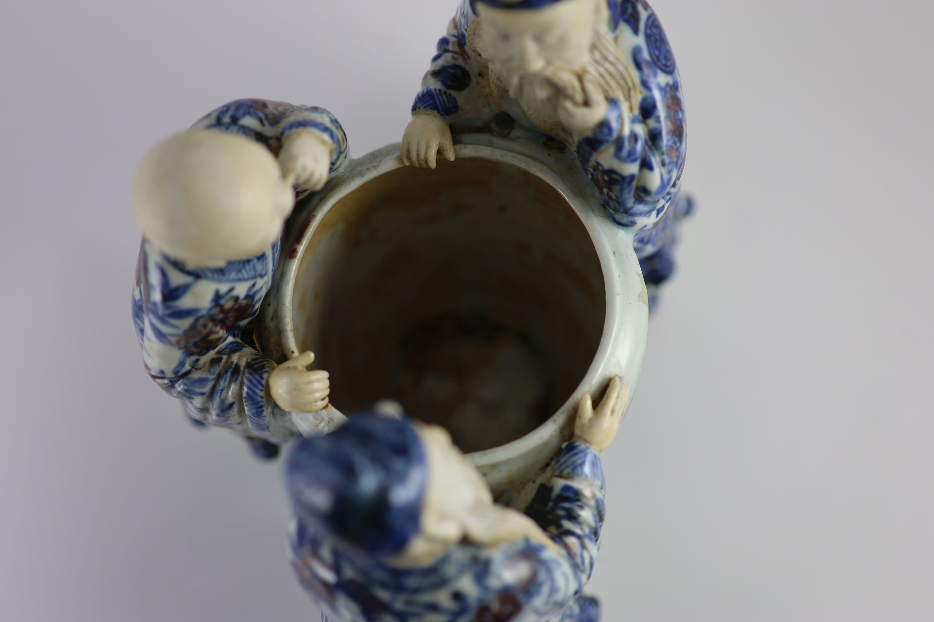 A rare Chinese underglaze blue and copper red porcelain model of the ‘Vinegar Tasters’, Qing dynasty, 26.cm high